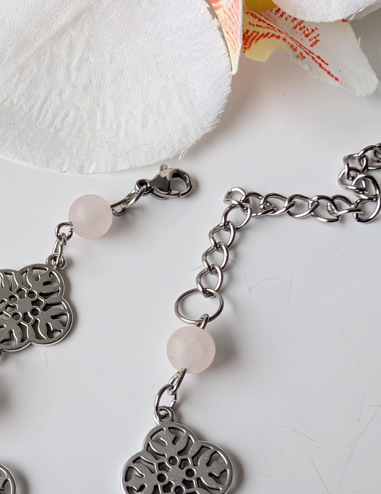 Delicate bracelet with ornate connectors and frosted rose quartz beads