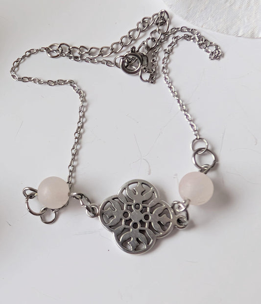 Delicate bracelet with ornate connector and 2 frosted rose quartz beads