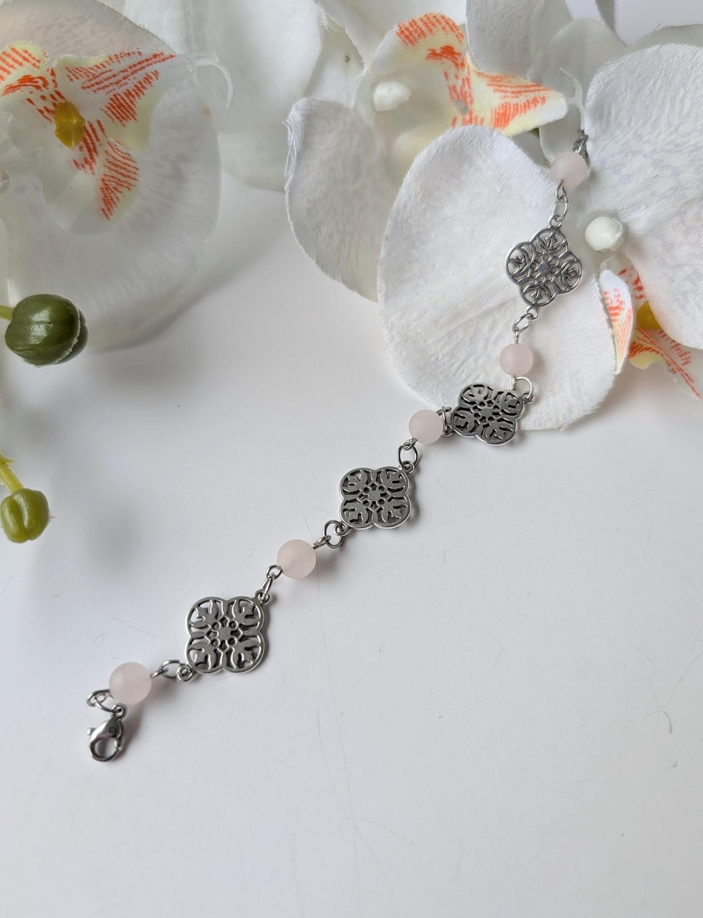 Delicate bracelet with ornate connectors and frosted rose quartz beads