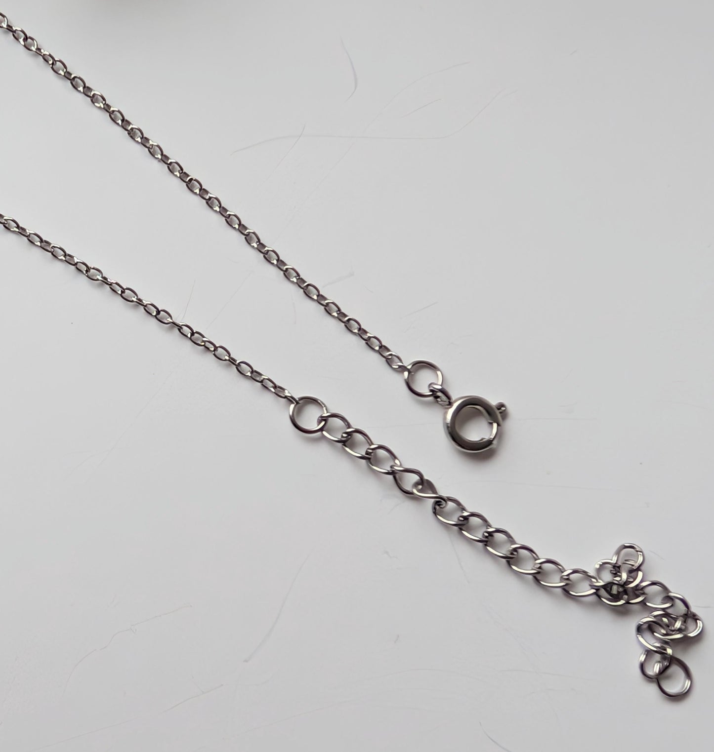 Delicate bracelet with ornate connector and 2 frosted rose quartz beads