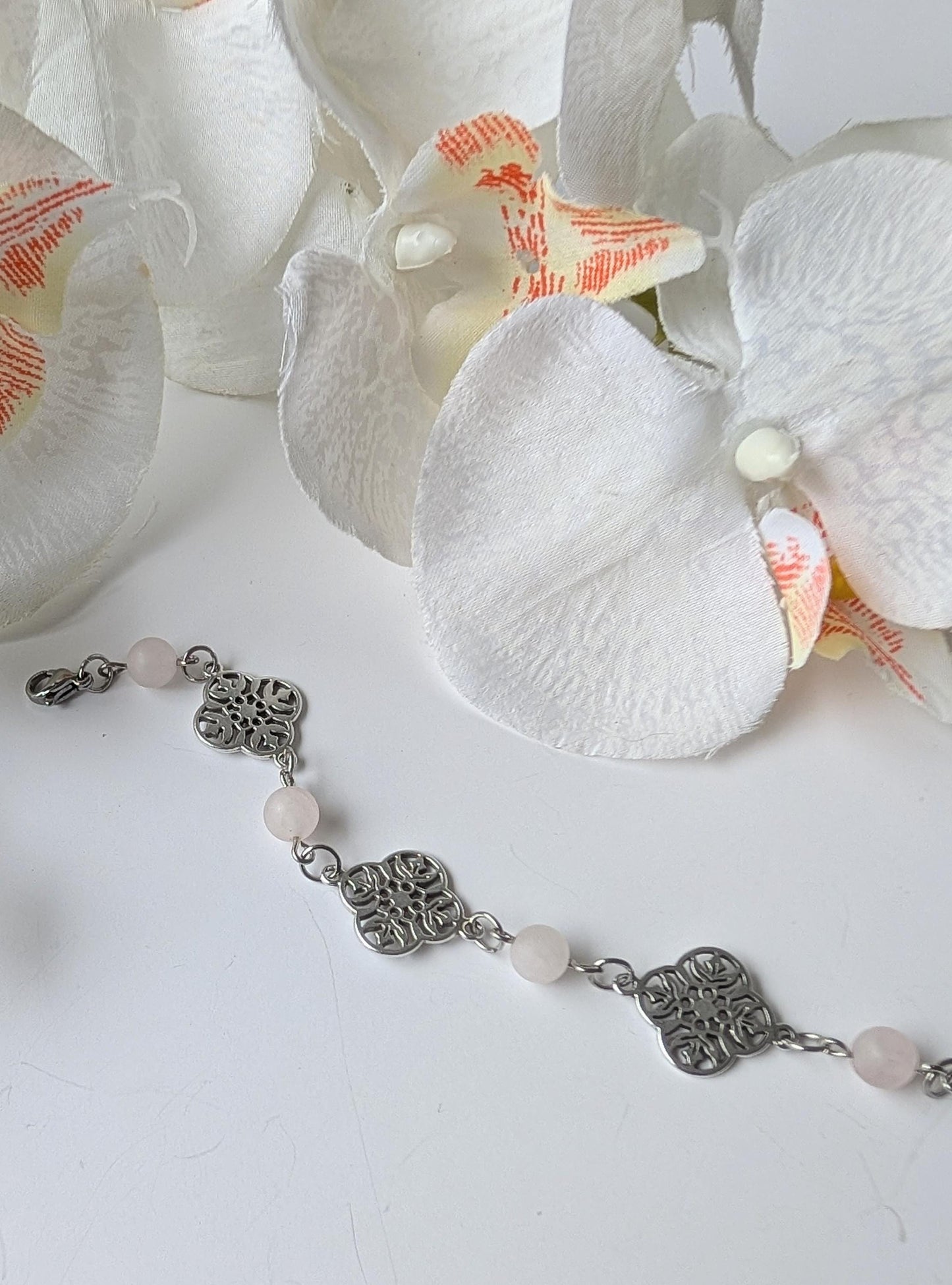 Delicate bracelet with ornate connectors and frosted rose quartz beads