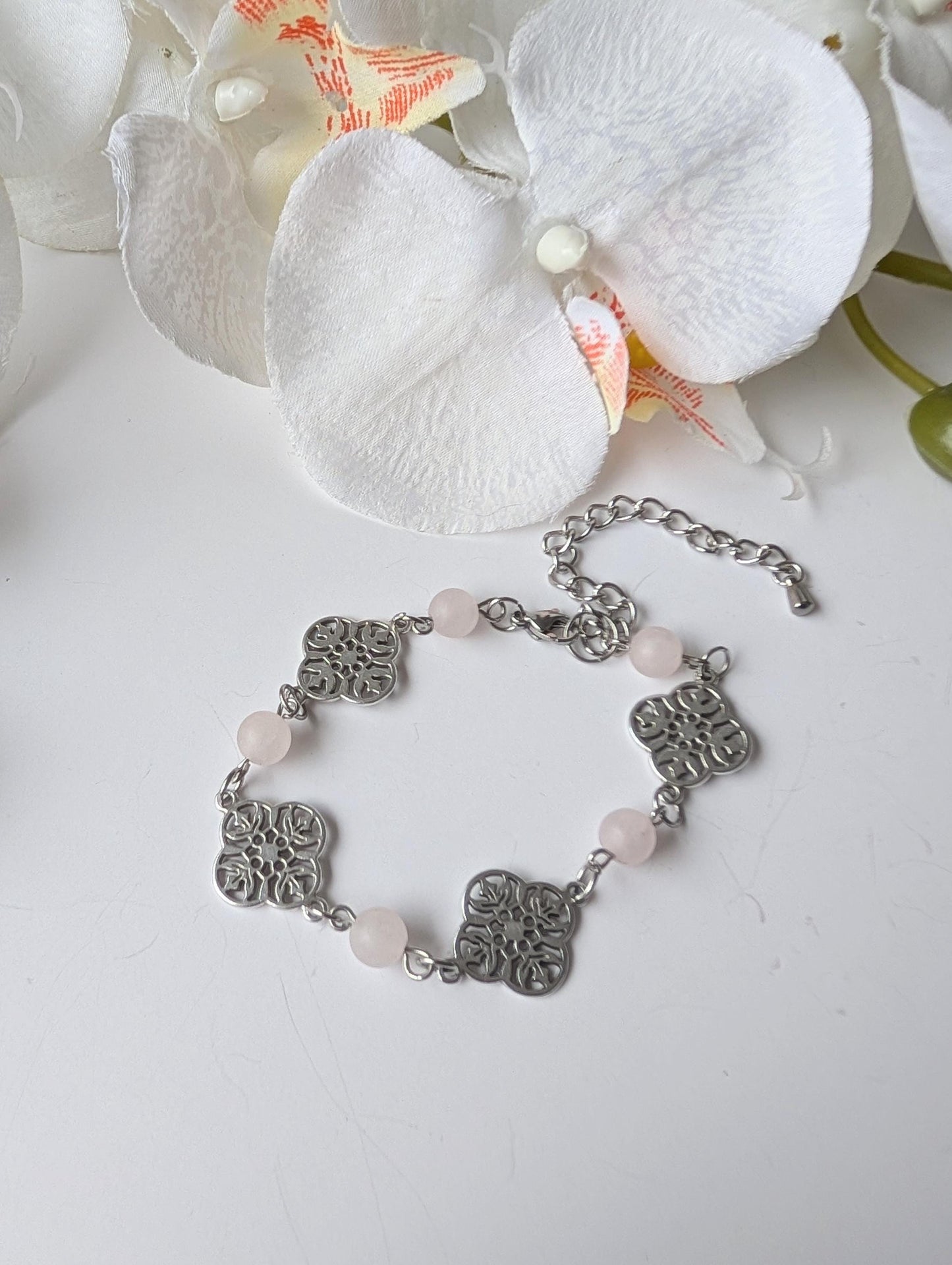 Delicate bracelet with ornate connectors and frosted rose quartz beads